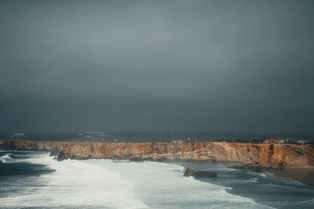 a stormy day at the beach with waves crashing on the shore