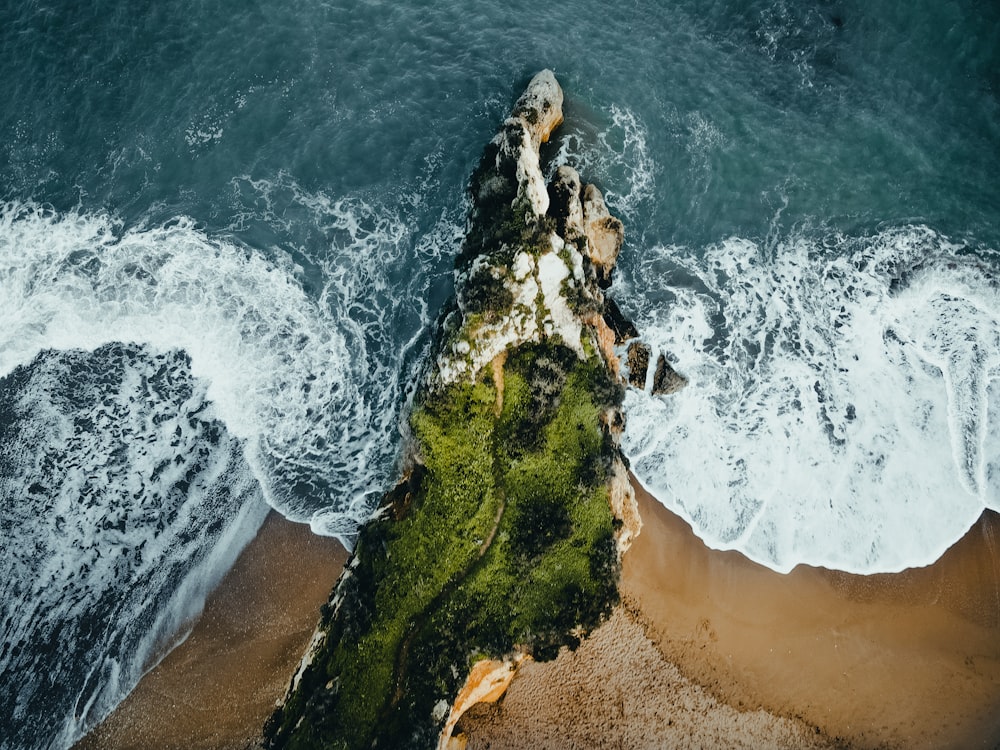 an aerial view of a beach with waves crashing on it