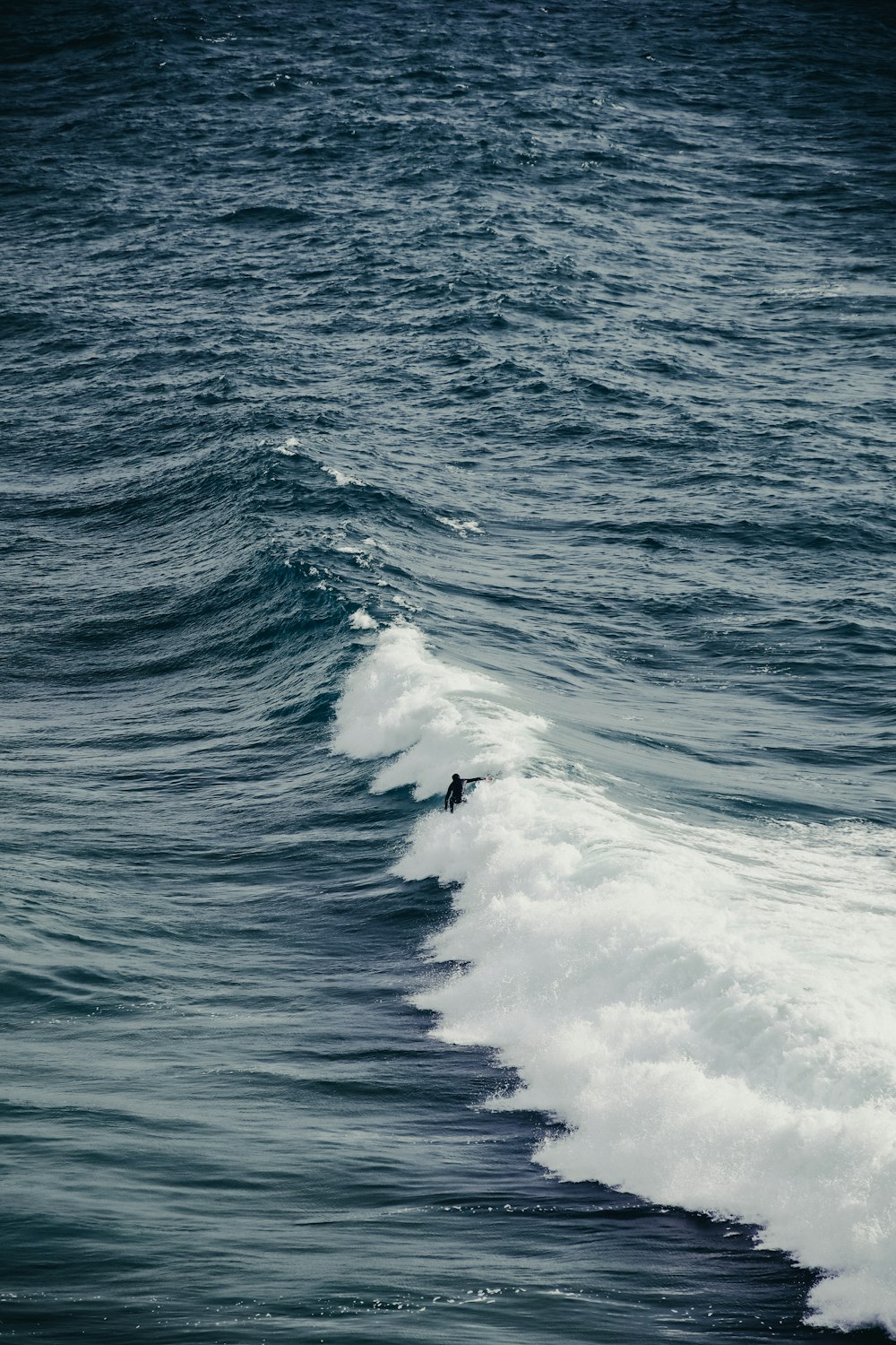 a person riding a wave on top of a surfboard