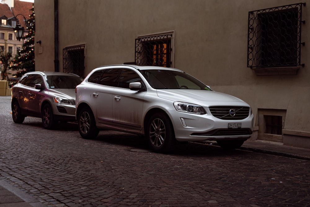 a couple of cars parked next to each other on a street