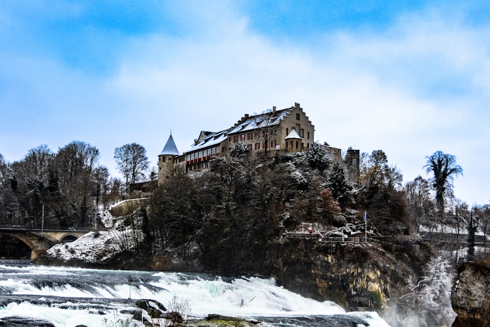 a castle on top of a mountain with a waterfall