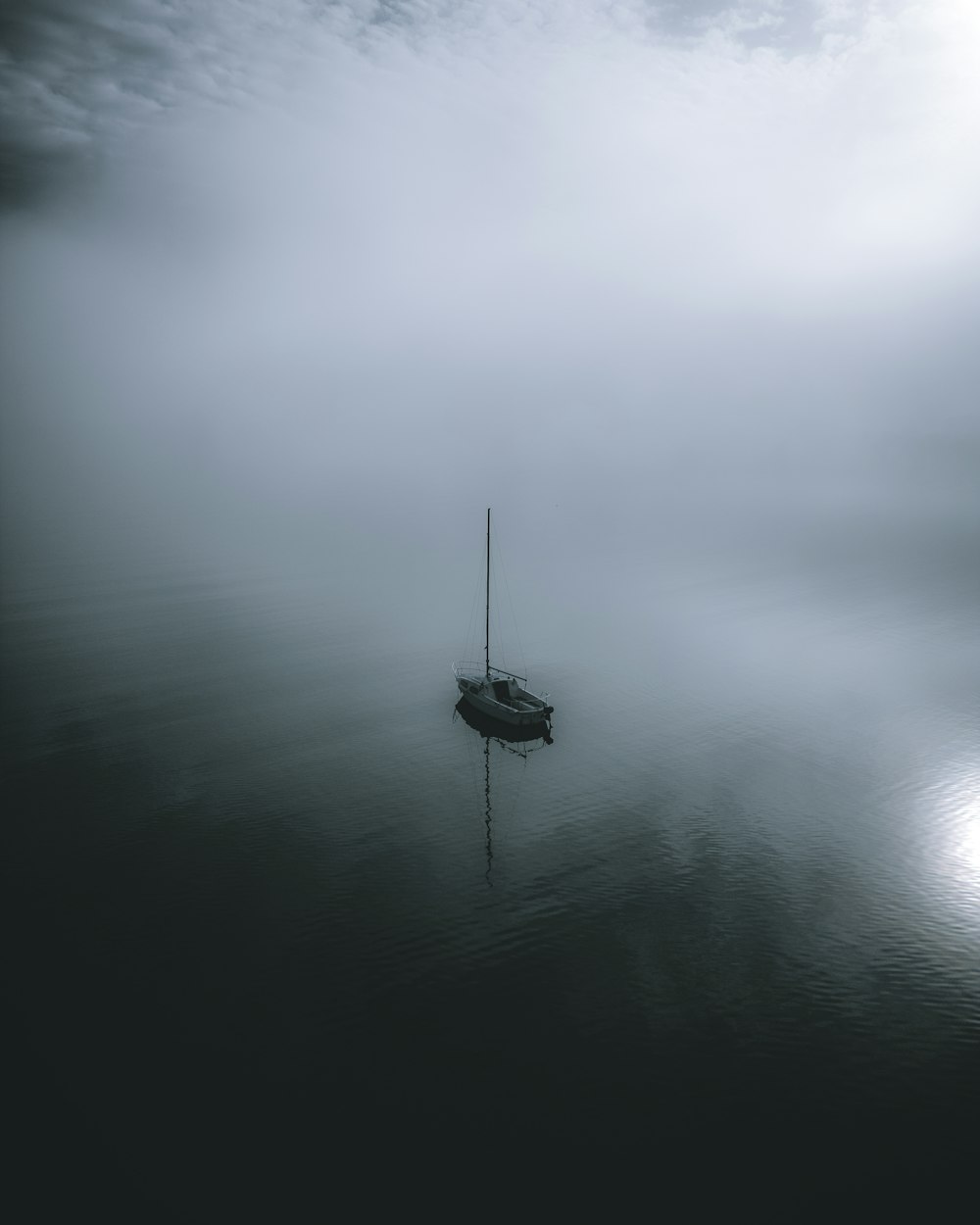 a small boat floating on top of a body of water