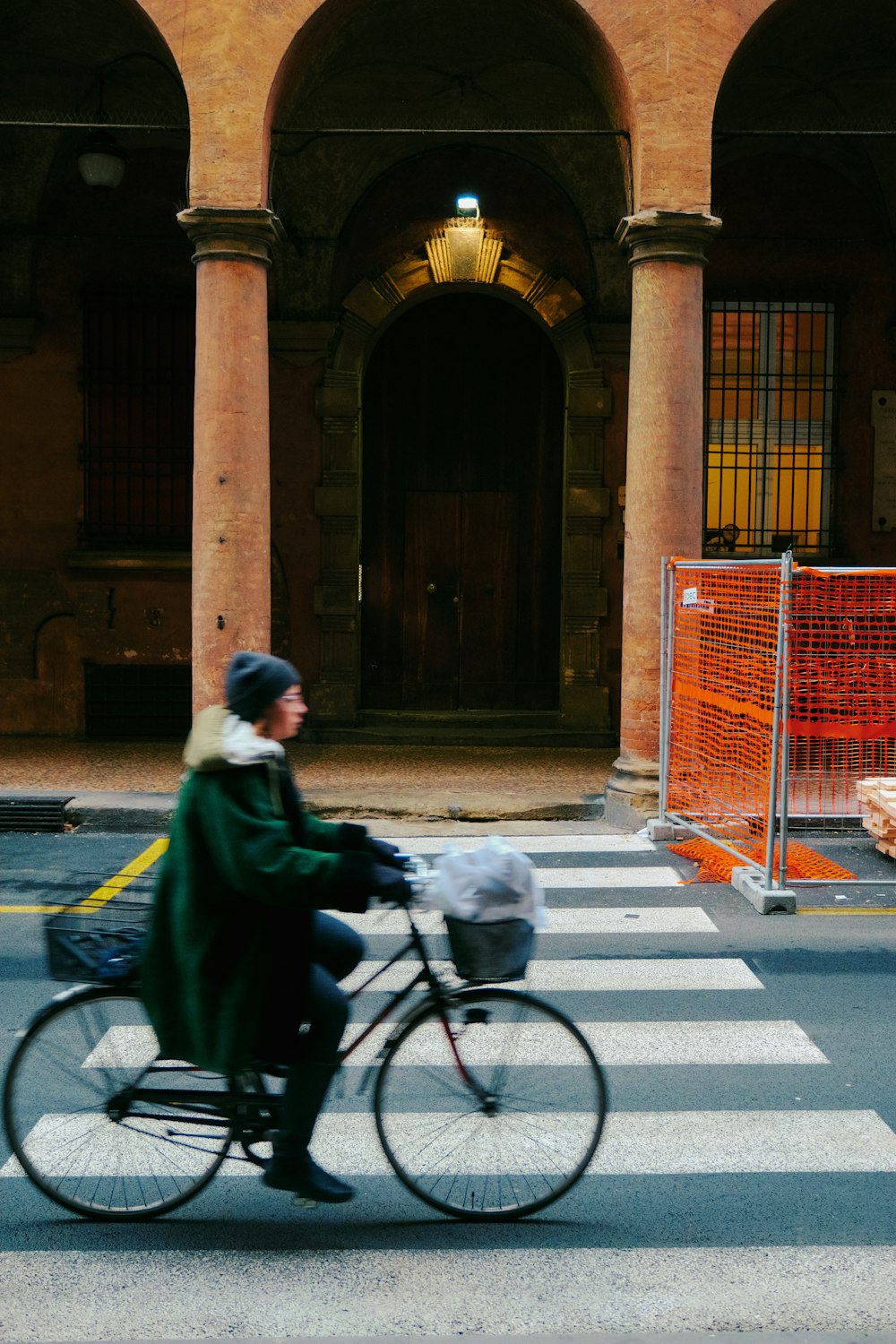 a woman riding a bike across a cross walk