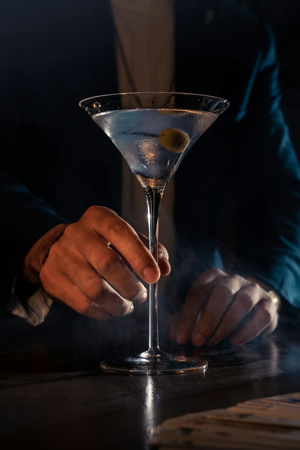 a man in a suit holding a martini glass