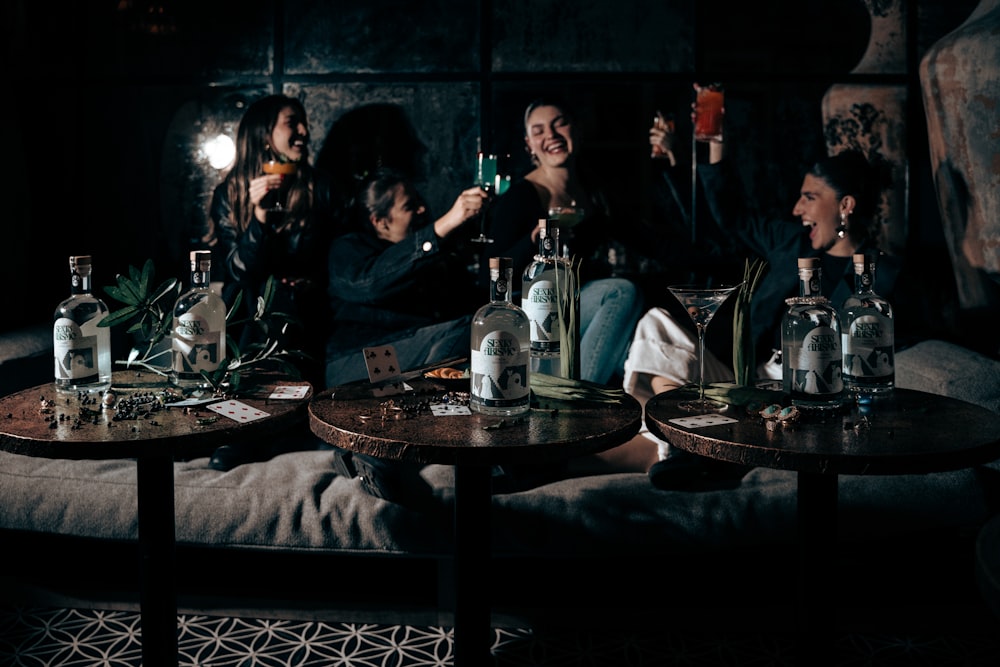 a group of people sitting around a table with drinks