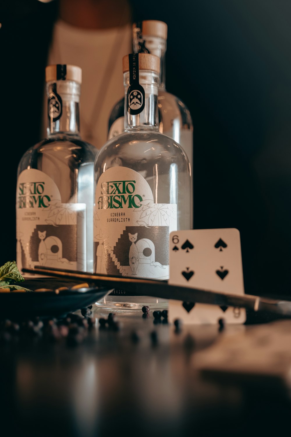 two bottles of alcohol sitting on top of a table