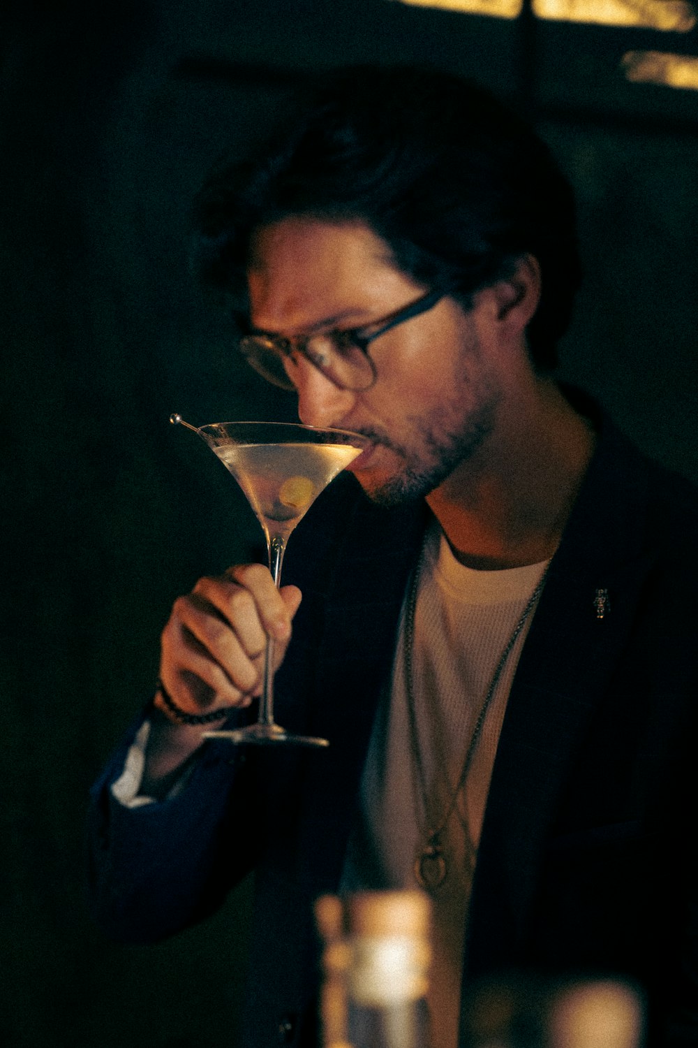 a man holding a martini glass in his hand