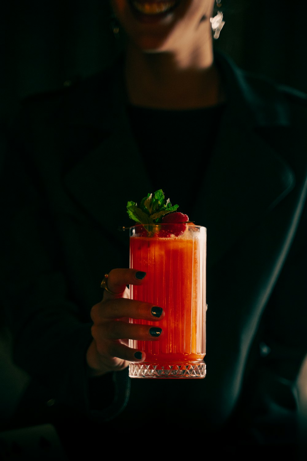 a woman holding a drink in her hand