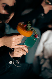 a woman holding a drink in her hand