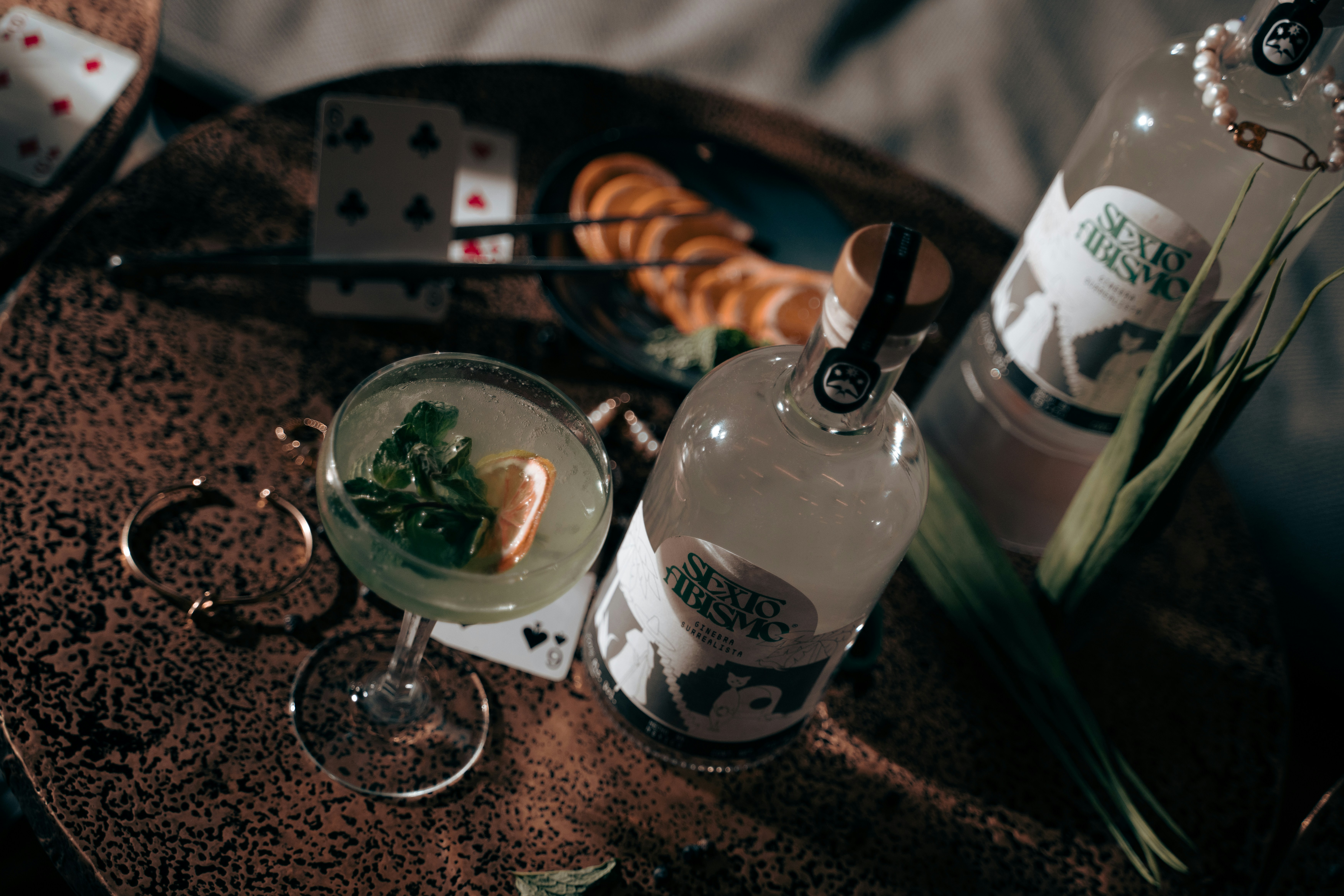 a table topped with a martini and a bottle of alcohol