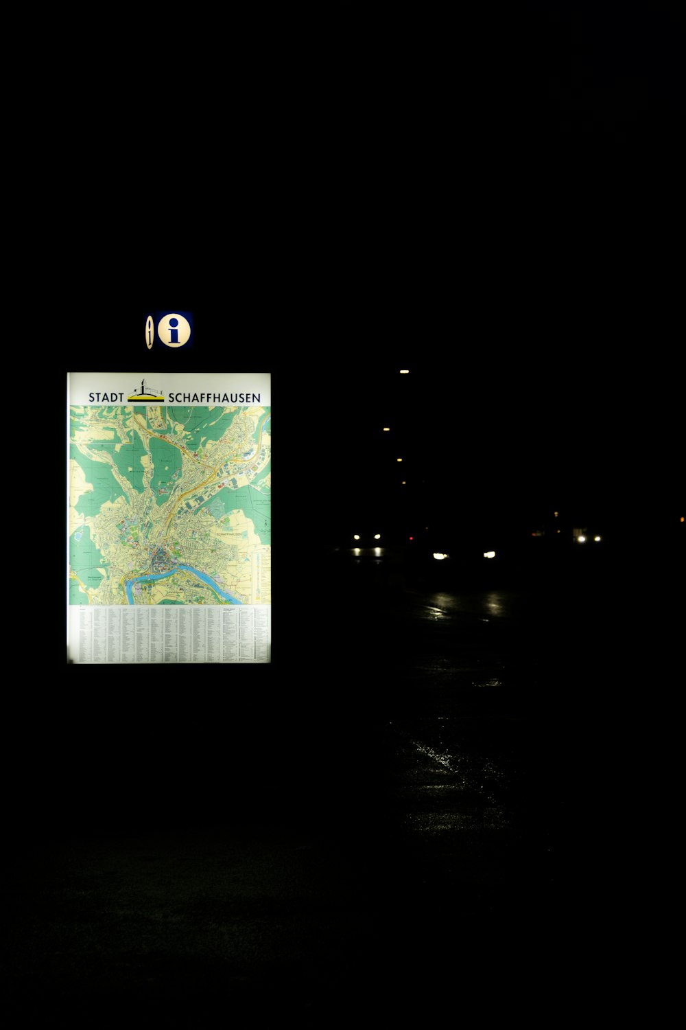 a map hanging on a pole in the dark