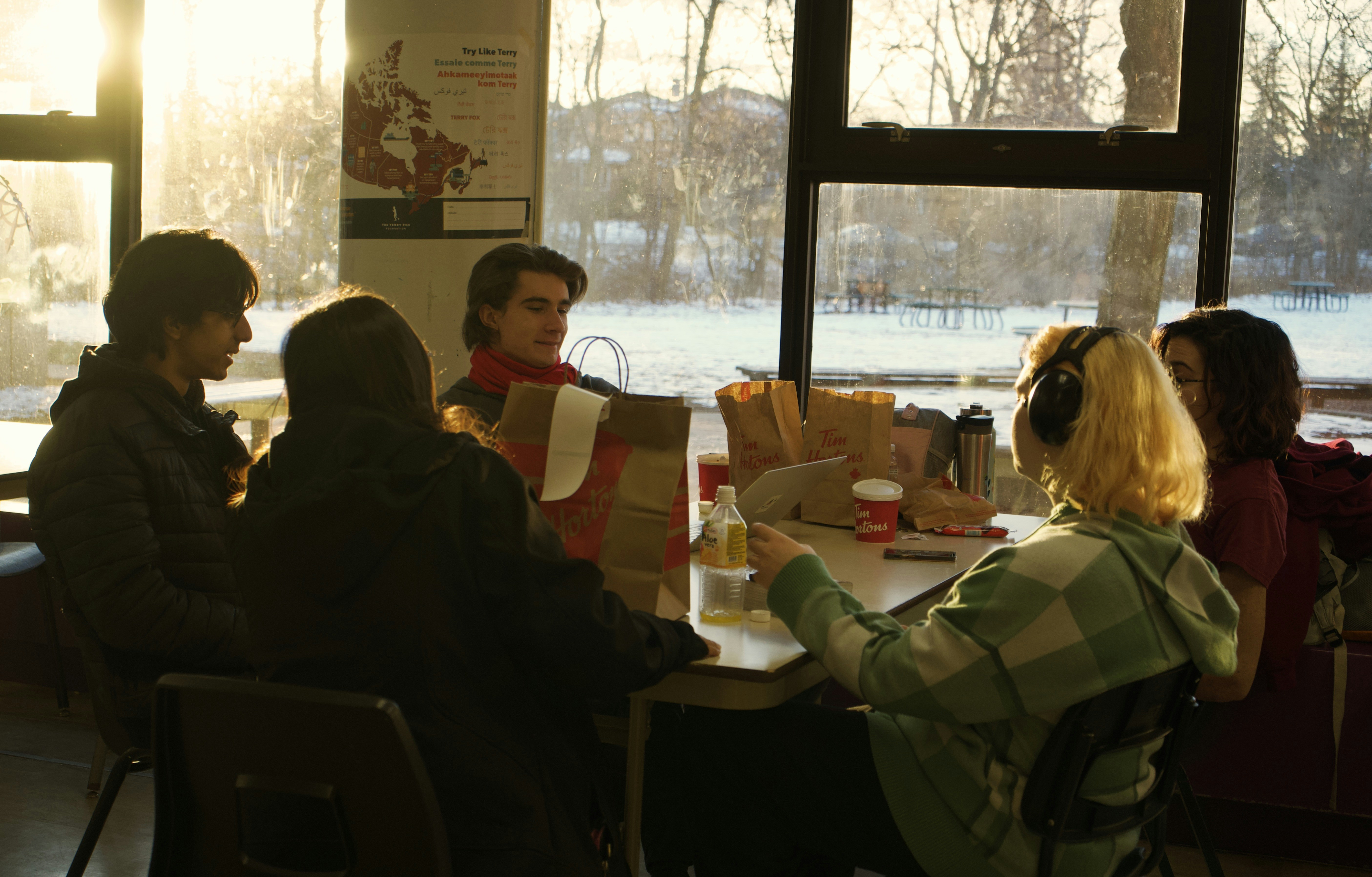 a group of people sitting around a table