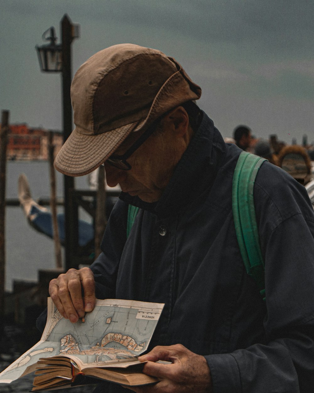 a man in a hat is looking at a map