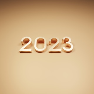 The numbers 2023 are prominently displayed in a three-dimensional style against a smooth, monotone background. The numbers have a metallic, glossy appearance, creating a modern and sleek look.