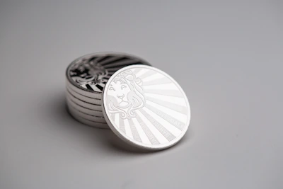 Elegant silver coins stacked neatly with subtle shadows highlighting their details.