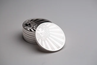 Stack of polished commemorative coins with detailed engravings.