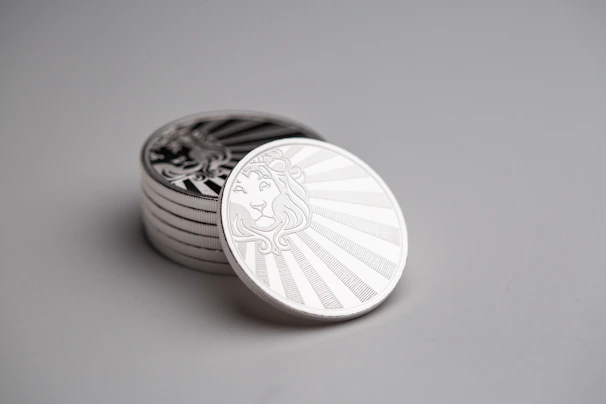 Stack of polished commemorative coins with detailed engravings.