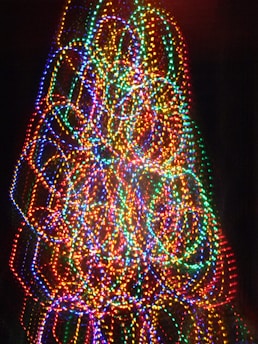 A vibrant Christmas light display on Vista Creek Drive, with colorful animated lights synchronized to music.
