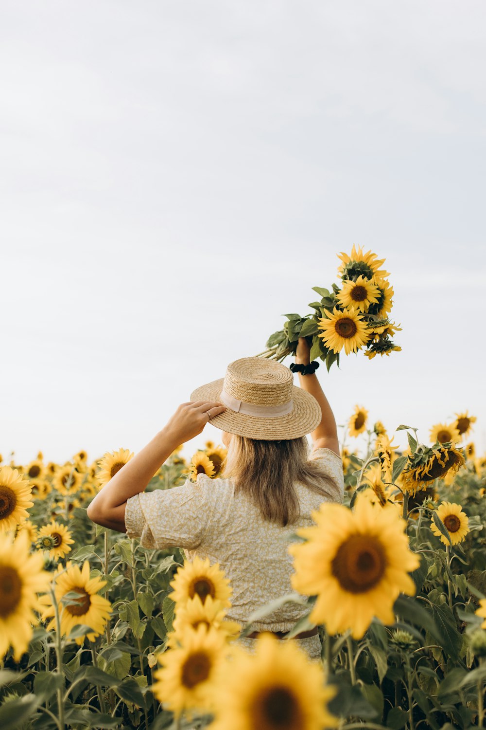 a woman standing in a field of sunflowers