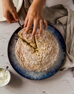 a person cutting into a pie with a knife