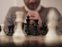 Close-up of a player strategizing during an Akong championship.