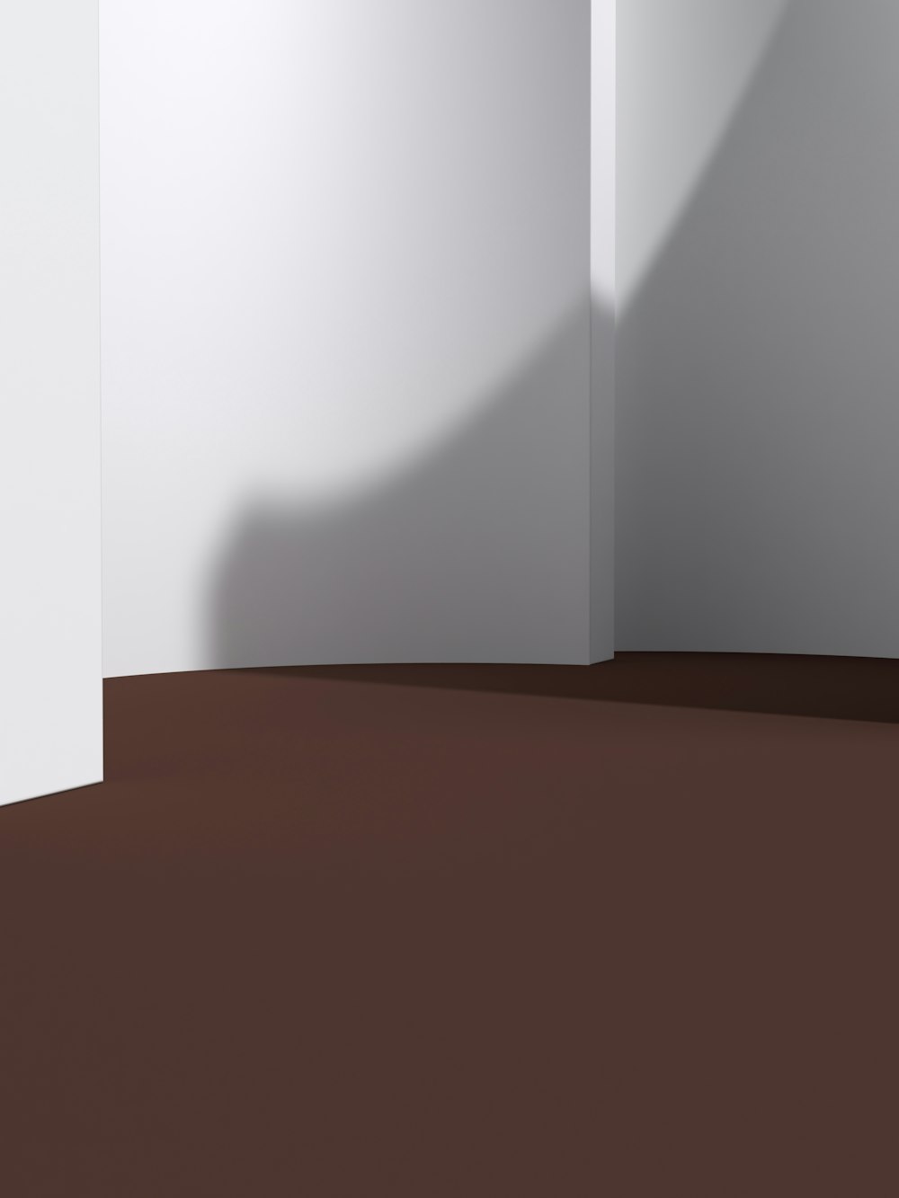 a white room with a brown floor and a white wall