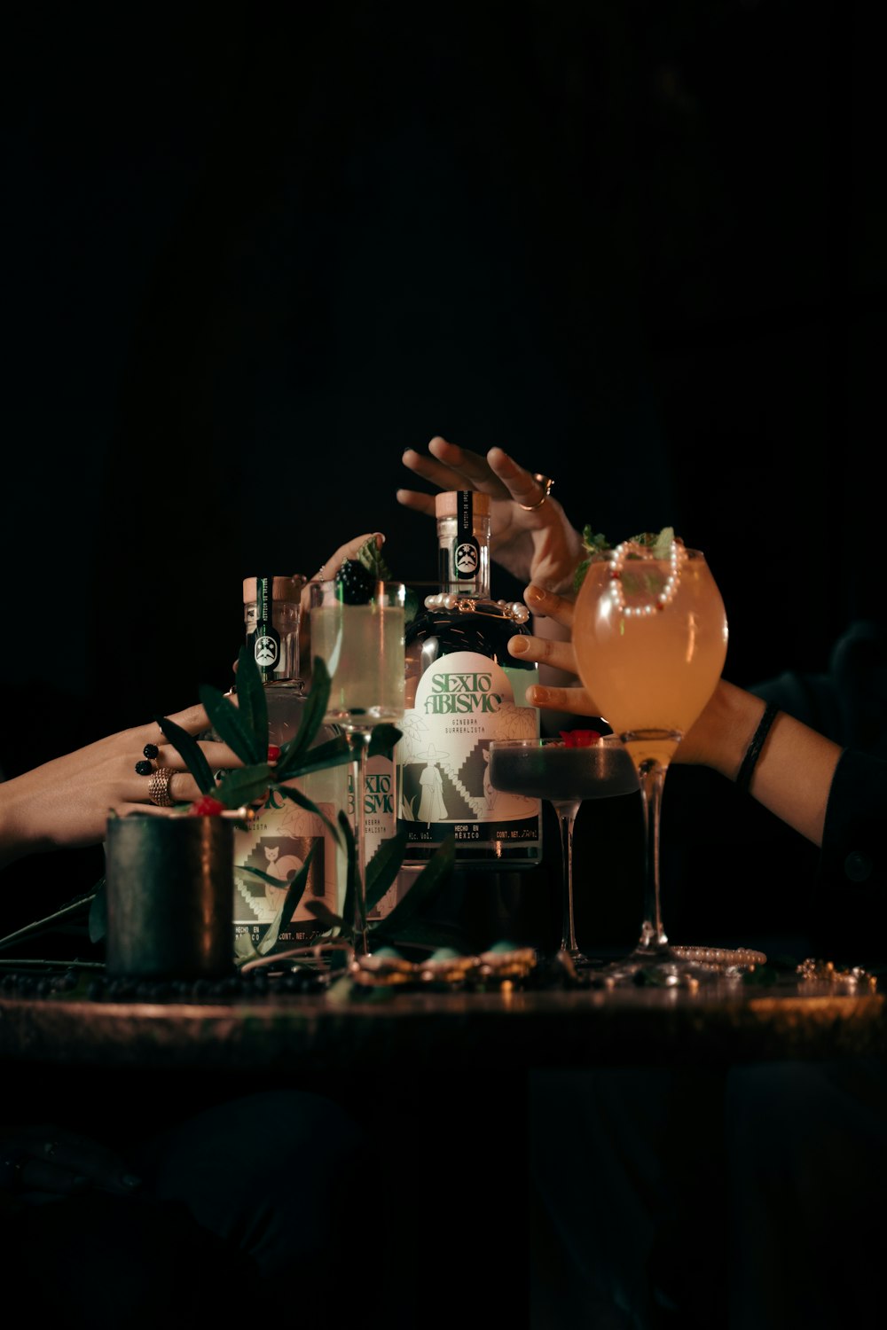 a person reaching for a drink at a bar