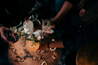 a couple of people holding glasses with drinks