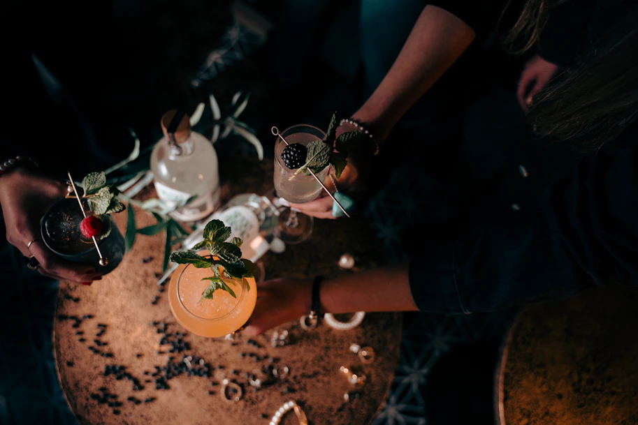 a couple of people holding glasses with drinks