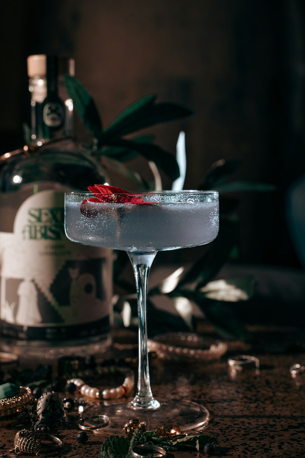 a glass filled with a drink sitting on top of a table