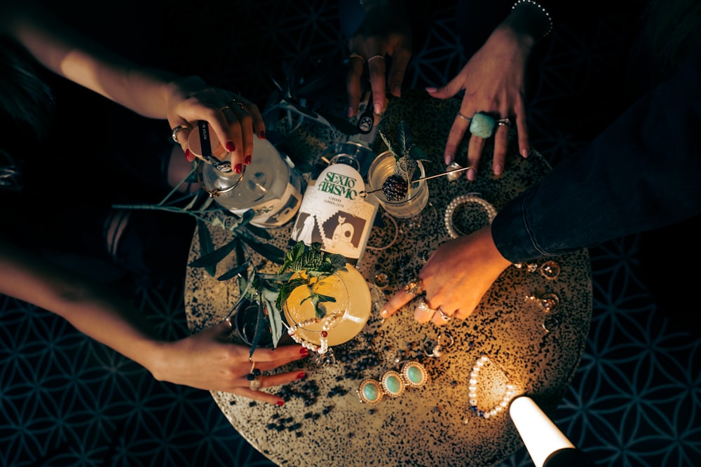 a group of people standing around a table with drinks