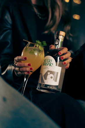 a woman holding a drink in her hand