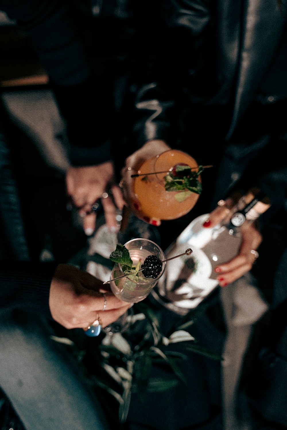 a group of people holding glasses filled with drinks