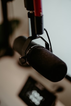 A close-up of a sturdy microphone stand in a professional studio setting.