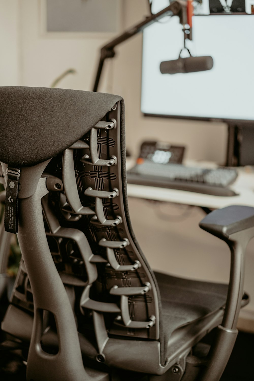 a computer desk with a monitor and a chair