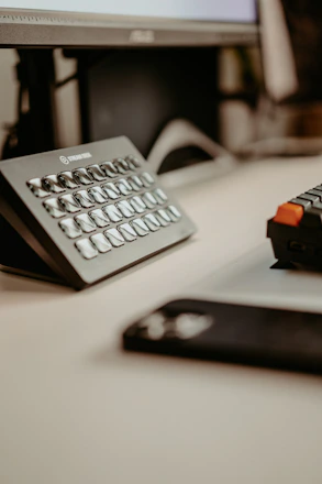A sleek black and red themed workspace with streaming devices and a laptop displaying setup instructions.