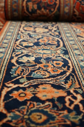 a carpet with a blue and orange design on it