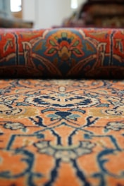 Blue and orange wool rug, a close up of a rug with a pattern on it
