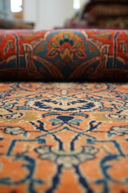Blue and orange wool rug, a close up of a rug with a pattern on it