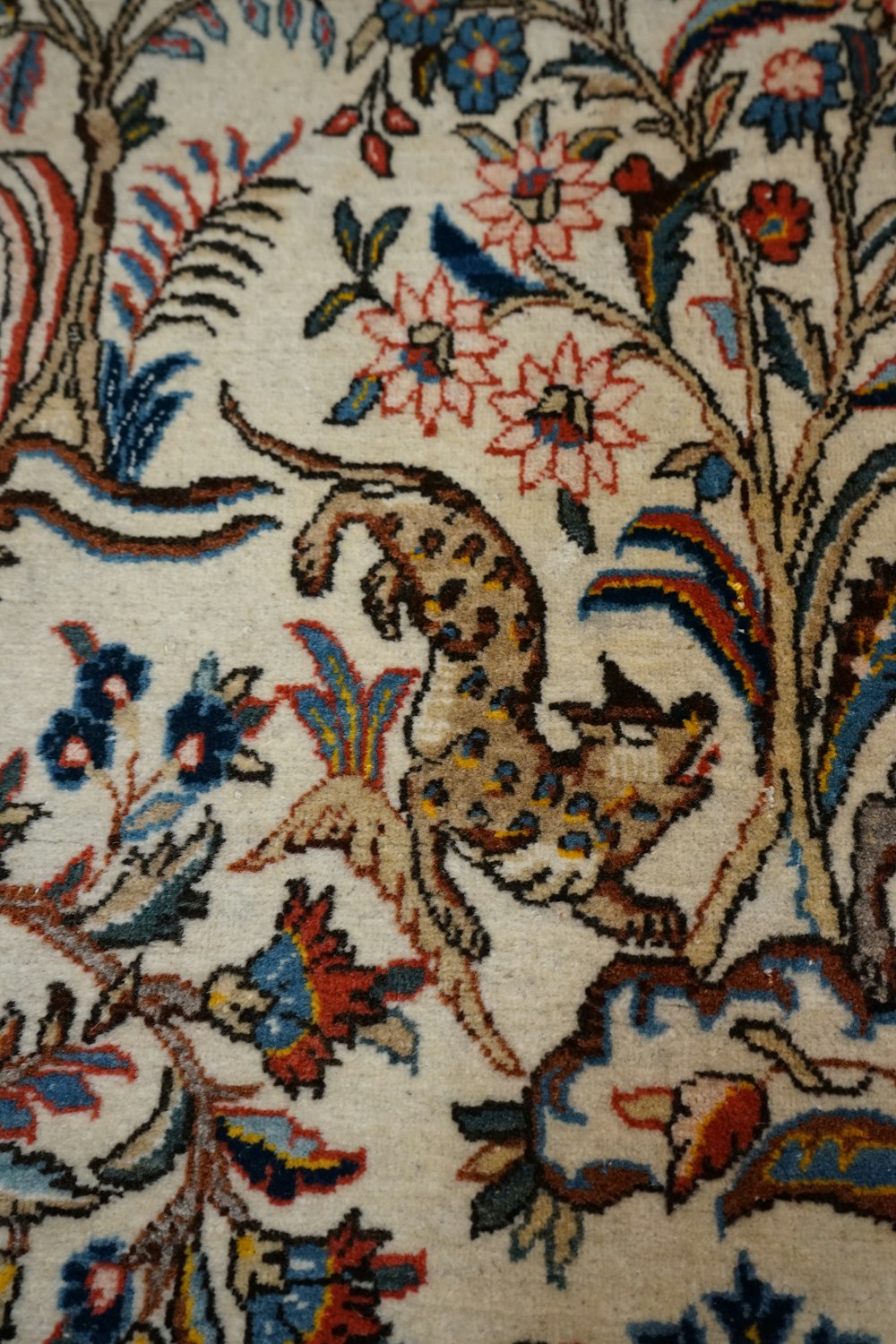a close up of a rug with animals on it