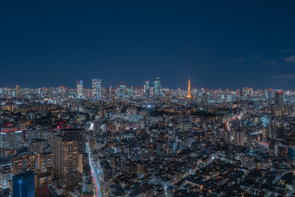 a view of a city at night from the top of a skyscraper