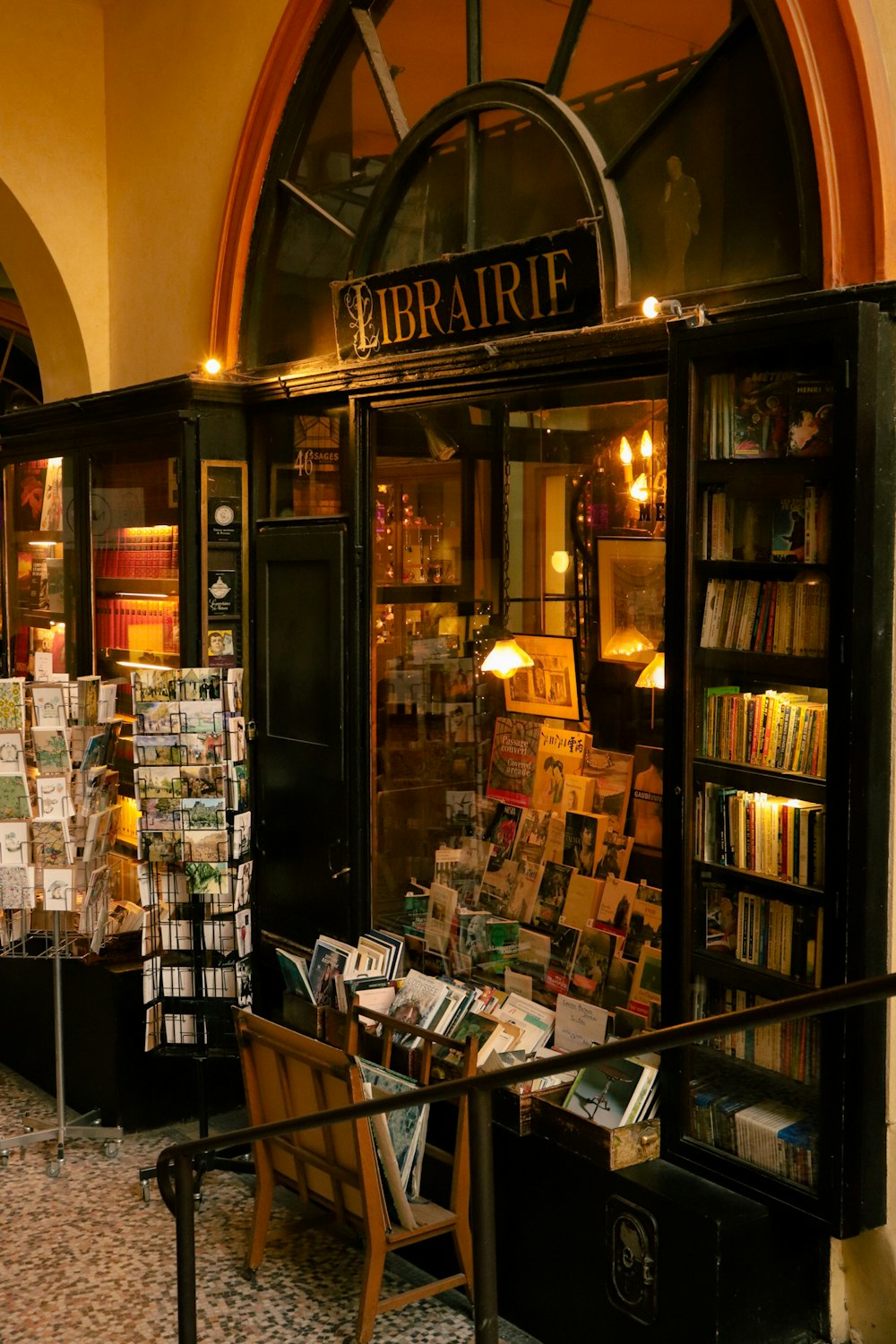 a bookstore with a table and chairs in front of it