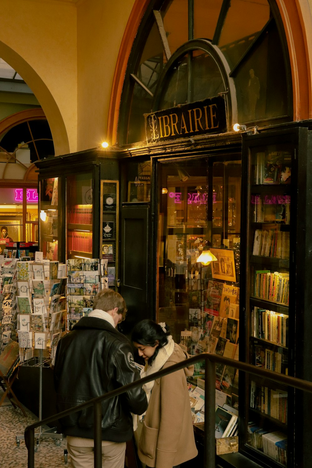 a couple of people that are standing in front of a book store