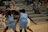 Close-up of basketball players in sleek, custom uniforms mid-game.