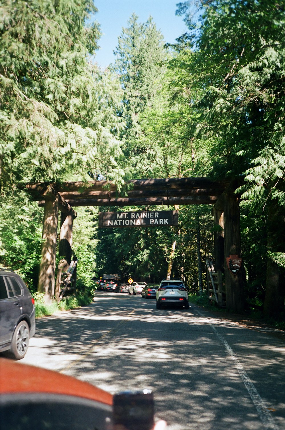 a car driving down a road under a bridge