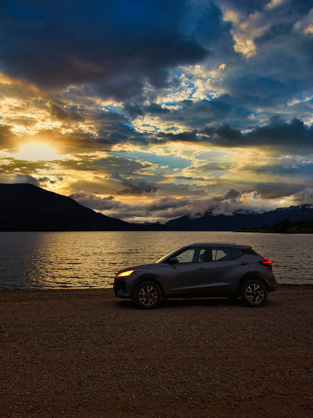 a car parked on the shore of a lake