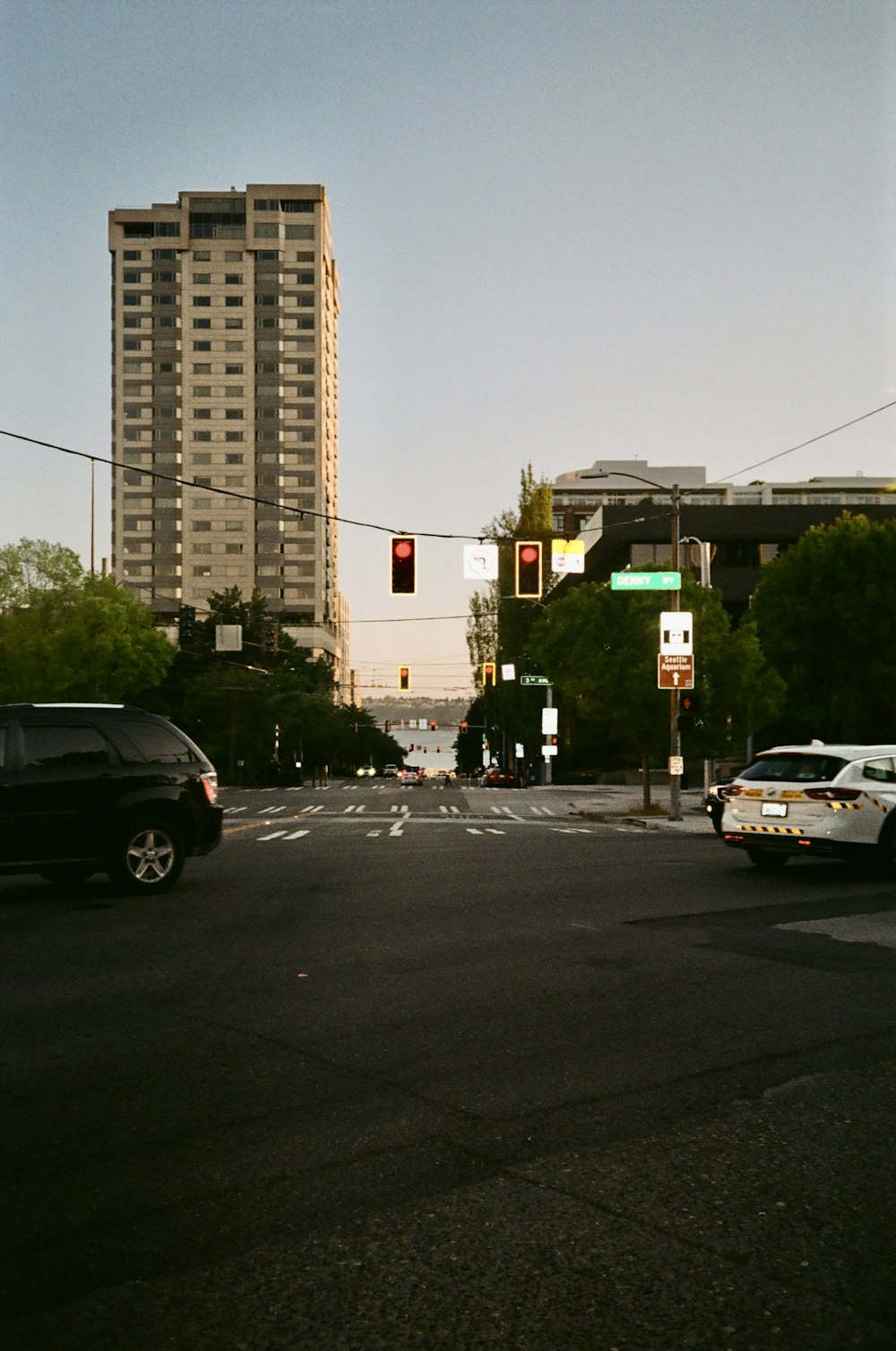 a city street with cars and a traffic light