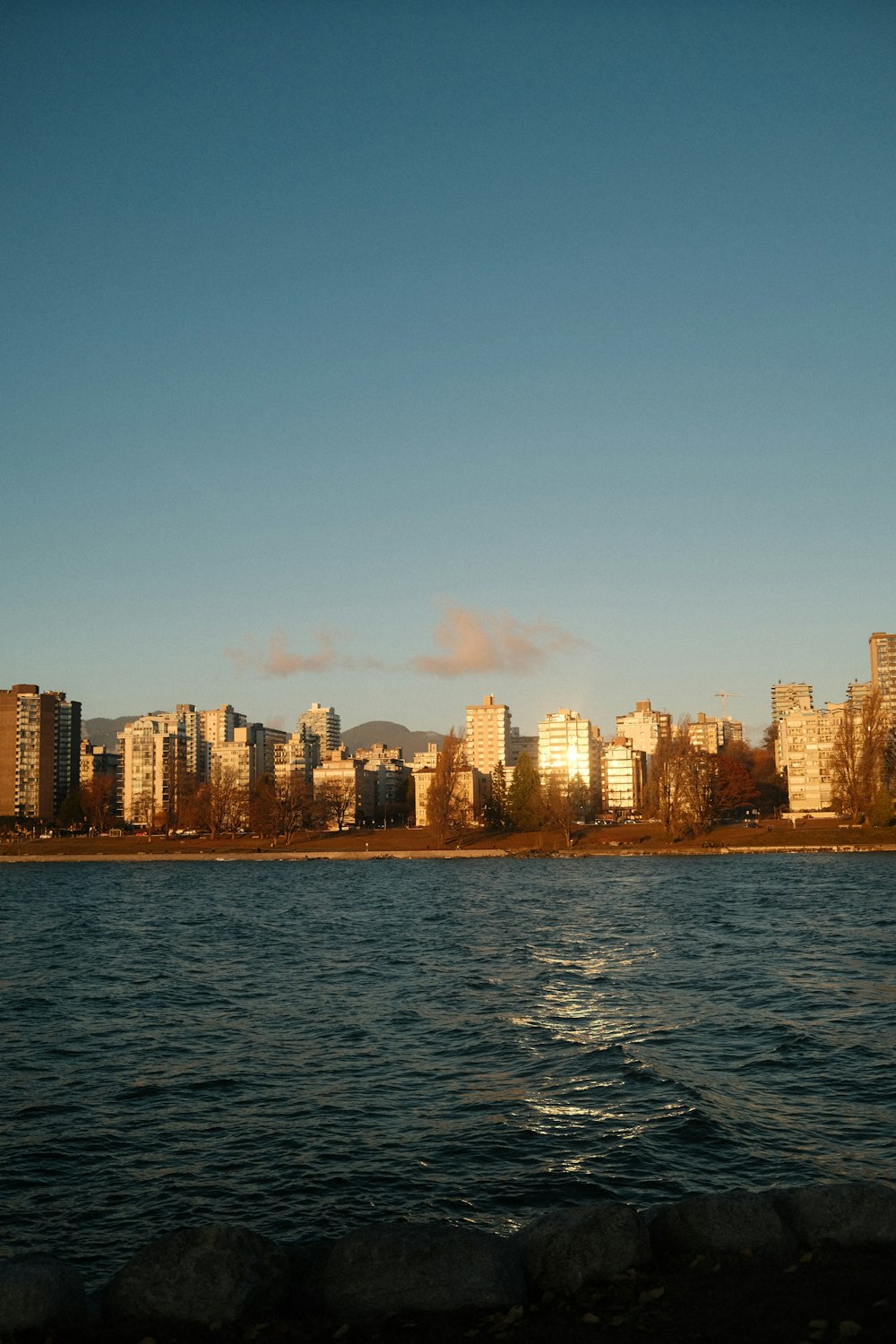 a large body of water with a city in the background