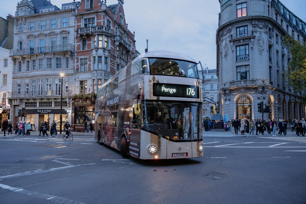 a double decker bus driving down a city street