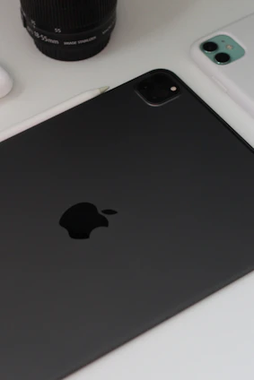 A close-up of smartphone and tablet devices with tech accessories